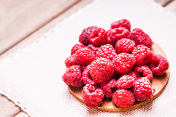 Raspberries on a wooden cutting board 