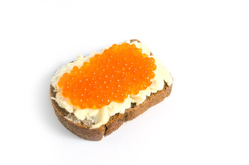 Red caviar and butter smeared on a piece of black bread
