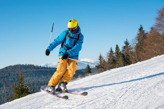 Man skier riding the slope on a beautiful sunny winter day on the winter resort