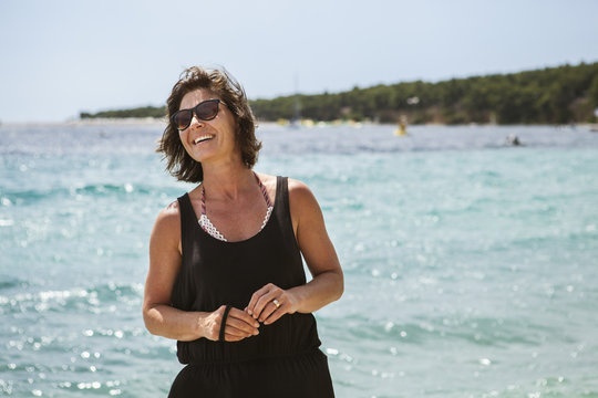 A smiling woman at the beach