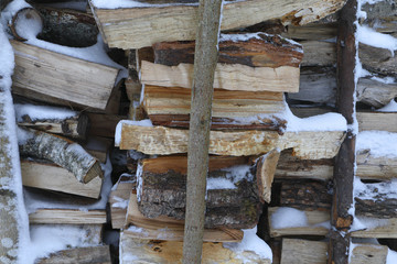 snow-covered firewood store 