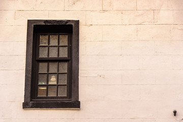 Fototapeta na wymiar Detail of a window in a white wall