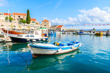 Fototapeta na wymiar Fishing boats anchoring in Bol port on sunny summer day, Brac island, Croatia