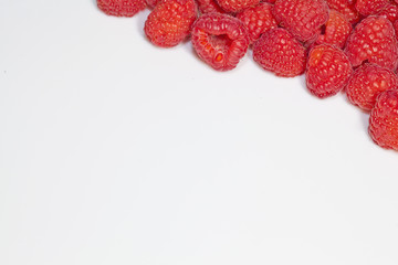Raspberries framed on white copy space.