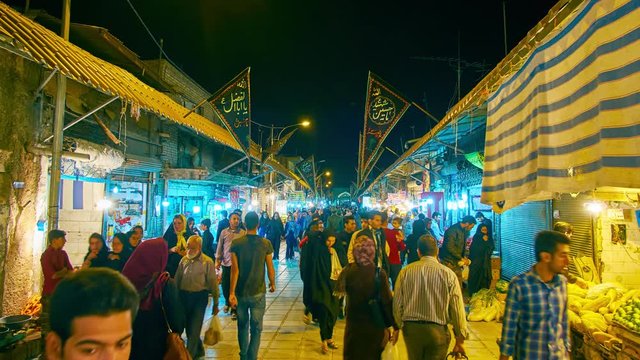 The busy evening in Ganjali Khan Bazaar -  central grocery market with wide range of fresh fruits, vegetables, spices and other goods, Kerman. 