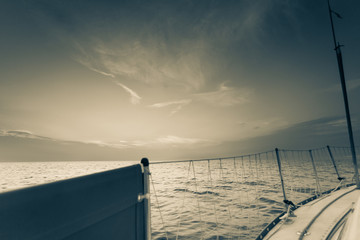 Yachting on sail boat during sunny dark weather