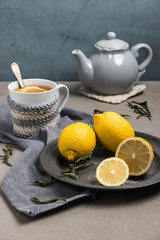 Cup of tea with lemon on table close-up. Healthcare traditional medicine and flu treatment concept.