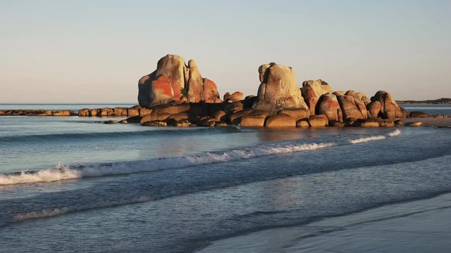 a  sunset view of the red granite picnic rocks in the bay of fires region on the east coast of tasmania, australia