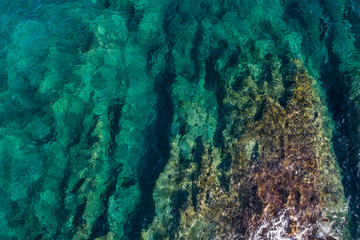 Fototapeta na wymiar Aerial view of the green waves that beat the sea cliffs