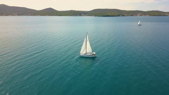 Yacht sailing on opened sea. Sailing boat. Yacht from drone. Yachting video. Yacht from above. Sailboat from drone. Sailing video. Yachting at windy day. Yacht. Sailboat.