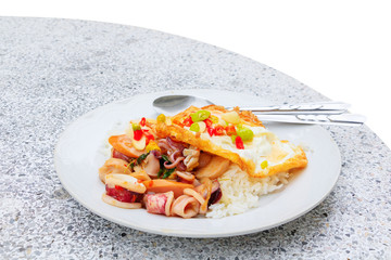 stir squid with basil on rice with fried egg, Thai food isolated on white background and clipping path