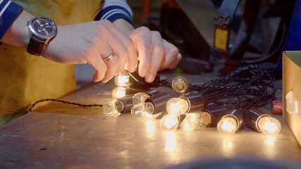 Man preparing lights for decorating house for christmas holidays, closeup