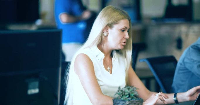 People working over computer screen in office 4k video. Business team at workplaces. Company staff in open space. Woman speaking