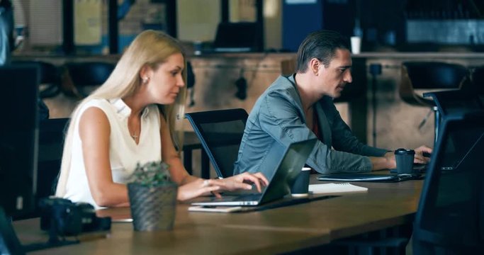 People working over computer screen in office 4k video. Business team at workplaces. Company staff in open space. Woman and man