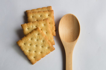 Wooden spoon with cookies wooden background