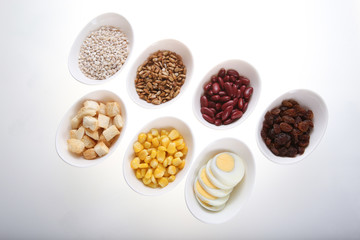 Group of  croutons, redbean, boiled eggs,sunflower seed, raisins and corn