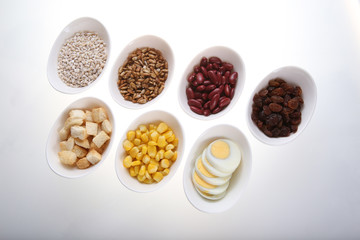Group of  croutons, redbean, boiled eggs,sunflower seed, raisins and corn