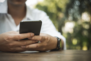 man holding smartphone outdoor. social network communication, wireless connection, lifestyle concept
