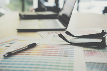 eyeglasses, color swatch on office desk. graphic designer workspace. creative design work. business workplace concept.