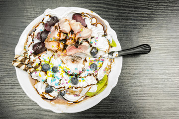 A teaspoon immersed in frozen dessert. View from above.