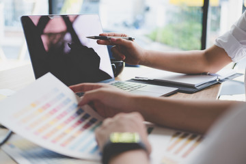 graphic or interior designer choosing color from swatch sample or catalogue palette guide at workplace. artist discussing design & idea at office. business people brainstorming for creativity project