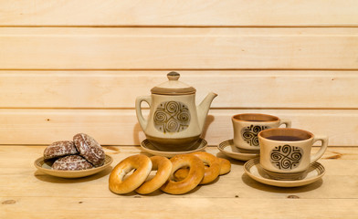 Pastry and tea-set on wooden background