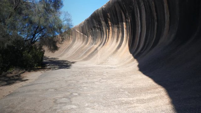 wide angle 3 axis gimbal  steadi-cam type shot walking along the rock formation in western australia known as wave rock
