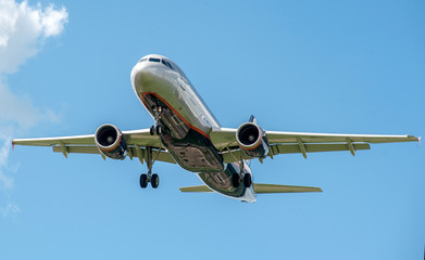 The plane on a background of blue sky and white clouds.