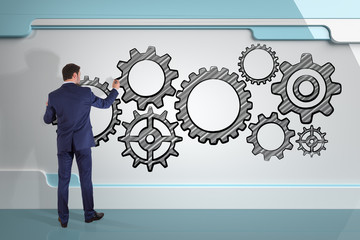 Businessman drawing gears sketch on a board 3D rendering