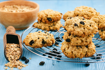 Homemade oatmeal cookies with raisins on blue table.