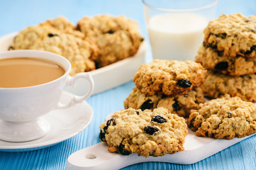 Homemade oatmeal cookies with raisins on blue table.