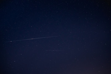 Two Meteoric Tracks In The Blue Night Starry Sky Background. Natural