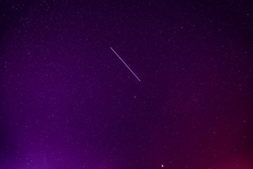 Meteoric Track In Violet Night Starry Sky Background. Glowing Stars