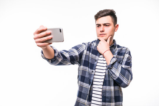 Happy young man taking a selfie photo isolated on white background
