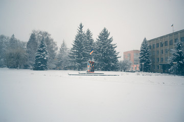 Winter day in a snowfall in the town.