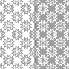 White and gray floral ornamental designs. Set of seamless patterns