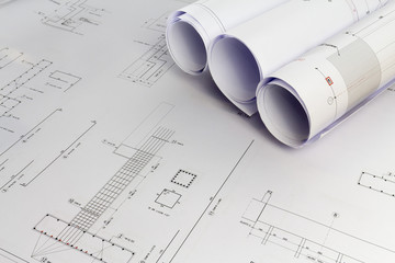Building design: Office desk with project drawings