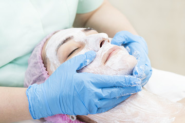 Obraz na płótnie Canvas Process cosmetic mask of massage and facials in beauty salon
