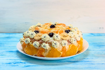 cake with oranges on a light wooden background