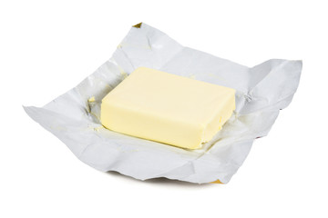 Piece of fresh butter on white background