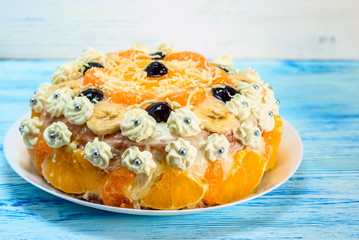 cake with oranges on a light wooden background