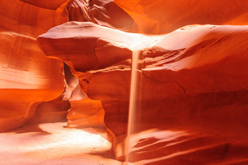 Sand Flowing off the Red Rocks of Antelope Canyon © Goldilock Project