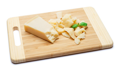 pieces of Parmesan cheese on wooden cutting board