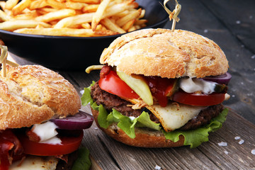 fresh tasty burger and french fries on wooden table