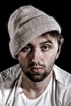 Unshaven man in a knitted hat