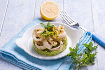 rings squid with  and grated lemon over zucchinis cream