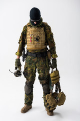 Full length portrait of serene soldier keeping ammunition in hands. Military concept