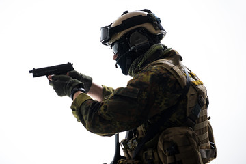 Side view serious defender wearing in ammunition firing with gun. Protection concept. Isolated
