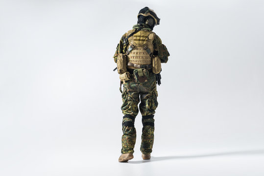 Full length soldier facing away while wearing protective military uniform. Maintenance concept