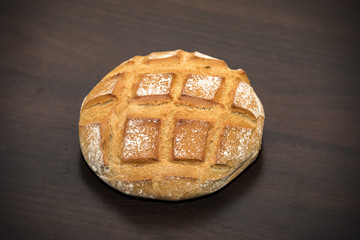 French rustic round bread posed on a table ready to be served for the breakfast in the early ;orning